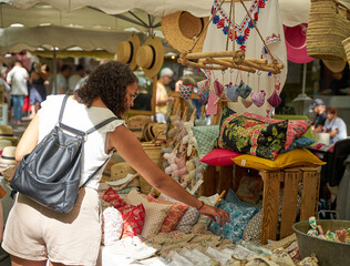 People looking at goods at the Uzès market, one of the most beautiful in France