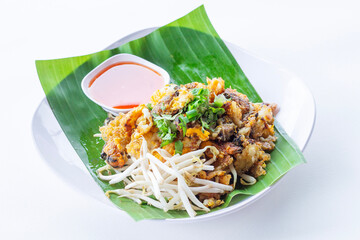 Thai-style fried Mussels are a popular one-dish meal. Made with mussels and batter that are fried until crispy. Place the plate with banana leaves on a white plate, isolate and white background