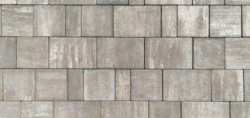 Obraz premium Gray paving stones. Paving surface road. Texture made of big gray cement bricks