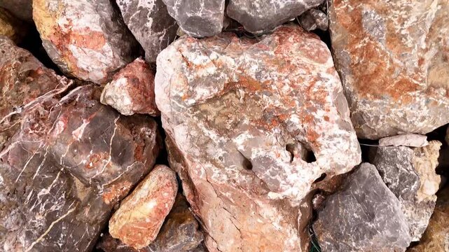 Background footage Beautifully arranged pebbles. Pattern Rocks. Video Rocks placed tightly on the ground. Rocks by the shore.