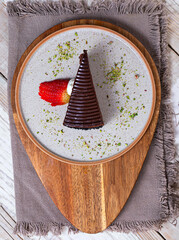 Chocolate icing pouring on slice of dark chocolate fudge cake. Delicious sweet chocolate cake...