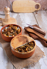 Baked meat in a clay pot, or a traditional pot dish, a stew with vegetables and meat cooked in the oven. Turkish and balkan or oriental food platter, flat lay
