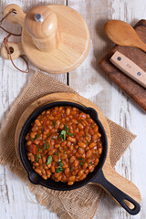 Bean and chorizo stew served in black plate
