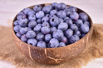 Blueberries in a coconut shell bowl. Close-up.
