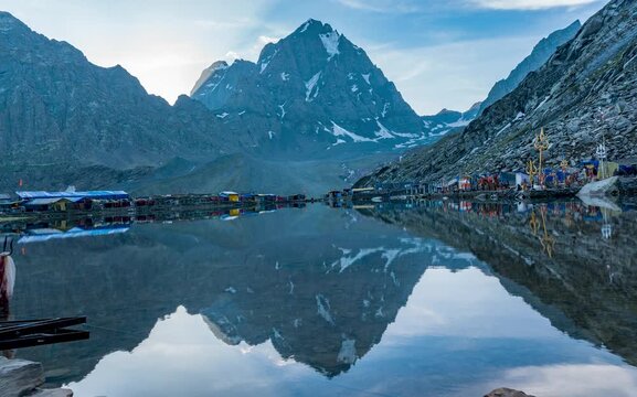 Breathtaking timelapse of Kailash Manimahesh Peak with its mirror reflection on Manimahesh Dal Lake, a sacred Hindu pilgrimage site of Lord Shiva in Chamba, Himachal Pradesh. Artistic timelapse.