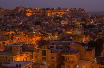 Jaisalmer, the Golden City, night view with yellow stone buildings and ancient fortress on the background, in the heart of the Thar Desert, Rajasthan India, Asia.
