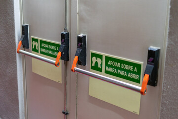 Emergency exit door panic bars with signage
