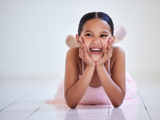 Ballet, funny and thinking with girl dancer in studio for recital, rehearsal or theatre performance. Art, floor and laughing with happy child student in dance class for break from classic dancing