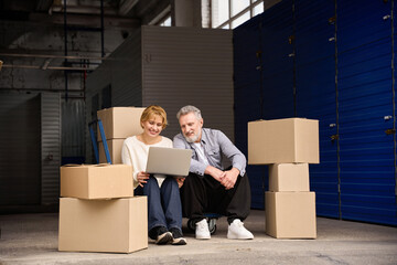 Woman sitting and working on computer near man