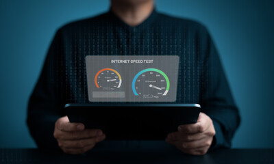 Internet speed bandwidth for network connection. Man using a digital tablet to test wireless networking or 5G cellular speed in Mbps or Gbps quality. WiFi 7 download or upload transfer rate.