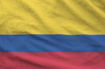Colombia flag depicted on folded wavy fabric of old cloth close up