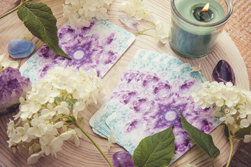 Deck with homemade divination Angel cards on wood table with hydrangea flower for decoration. Home...