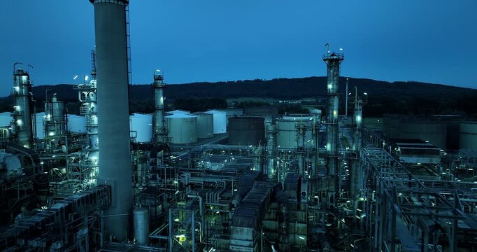 Industrial refinery at dusk with machinery, towers, elements of energy industry