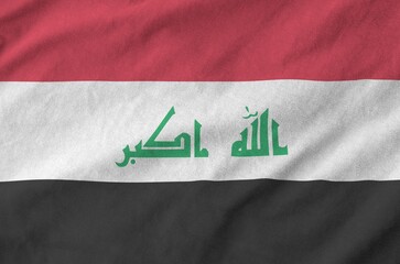 Iraq flag depicted on folded wavy fabric of old cloth close up