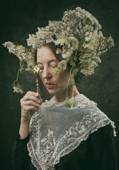 woman with bouquet of cow parsley on her head in romantic attitude with a teaspoon VIII