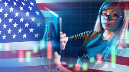 Woman trader from USA. Businesswoman works with electronic tablet. Girl trader near US flag. Lady trades on American stock exchange. Business woman buys and sells American stocks. Trader near charts