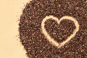 Heart drawn on spilled fruit tea, texture. Top view of tea made from apple, cinnamon, lemon zest, hibiscus flowers, licorice root and cloves. Tea composition. Ingredients for a hot drink, close-up