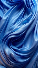Obraz premium A close-up image captures the intricate and flowing textures of a blue fabric-like material. 