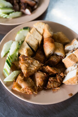 Snack and dessert, Chinese traditional deep fried tofu or fried bean curd served with cucumber slice and eating with sweet and sour spicy sauce.