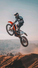 A man is riding a dirt bike and doing a trick in the air