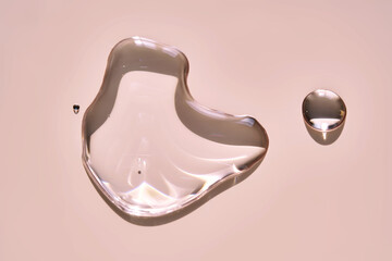 A drop of micellar water on a pink background.