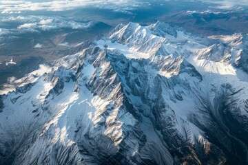 Obraz premium This photo captures an expansive aerial view of a snow-covered mountain range, showcasing the majestic peaks and valleys below, Majestic peaks of the Swiss Alps from a top-down view, AI Generated