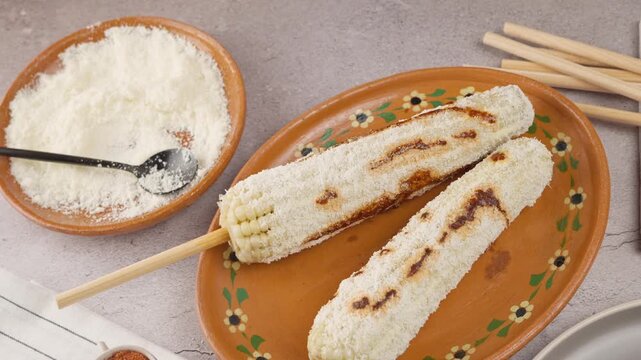 Prepared elotes accompanied with all the ingredients used in its preparation, View from above