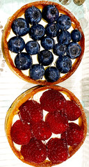raspberry and blueberry cheesecake in a waffle baskets