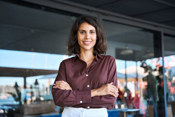 Portrait of beautiful successful confident hispanic young business woman looking proud at camera....