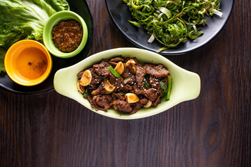 Goguryeo Beef Bulgogi with spicy sauce served in dish isolated on wooden table top view of korean food