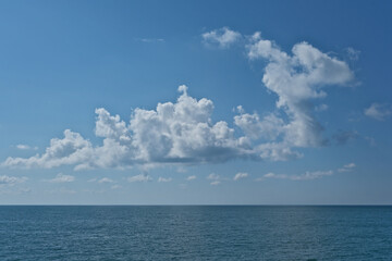 Beautiful clouds in the blue sky over the sea. Nature background