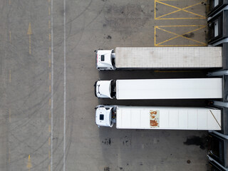 aerial drone view of Trucks at a Loading Dock in distribution center 