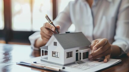 Fototapeta premium Real estate agent home sales broker is using a pen pointing to the house model and explains the business contract, rent, buy, mortgage, loan, or home insurance AI generated