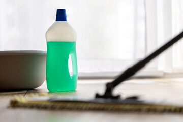 cleaning agent bottle and mop , floor cleaning and homework concept