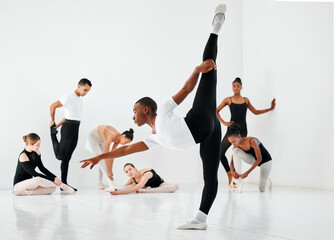 Ballet, dance and group warm up with practice stretch for performance art, elegance or learning. Diversity, ballerina and students with training in class for dancing academy, teamwork and balance