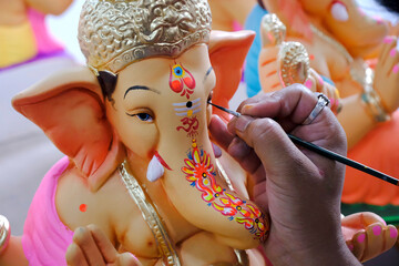 Artist painting and giving final touches to Lord Ganesha, ahead of 