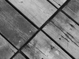 Wooden floor on the beach affected by wind and salt water, black and white picture
