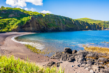 Fototapeta premium Stunning beach with ocean cliffs in Mosteiros town, Sao Miguel island, Azores, Portugal