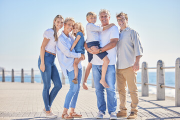 Family, portrait and grandparents hug in outdoor, promenade and trip for support in nature. Parents, generations and children for embrace on vacation, bonding and holiday for seaside freedom travel