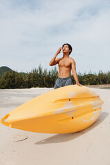 Kayak Fun: Happy Asian Man Exercising in Tropical Beach Vacation with Oar and Paddle.