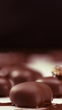 Confectioner decorated delicious heart shaped candy in coffee shop. Confectionery counter with sweet tasty desserts. Candy on Valentines day