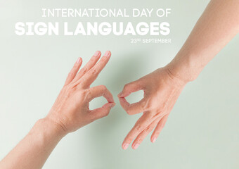 International Day Of Sign Languages concept with human hands making symbol "Connect" on pale green background