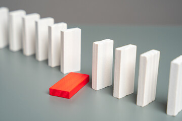 A domino that has fallen out of a row of standing dominoes. Out of order. Health problems. Weak...