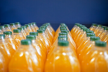 orange juice and other drinks packed in plastic containers with green plastic lids