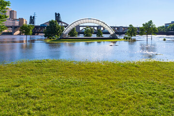 part of raspberry island regional park  submerged under mississippi river floodwaters with bandshell visible and robert street bridge behind it