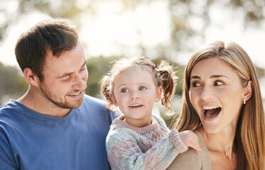 Happy, park and parents with child for playing for fun, bonding and playful relationship. Family, nature and excited mom, dad and girl for adventure outdoors for care, love and support on weekend