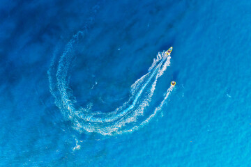 Vacation and leisure. Aerial view on fast boat on blue sea at sunny day. Fast ship on the sea surface. Seascape from the drone. Seascape from air. Seascape with motorboat.