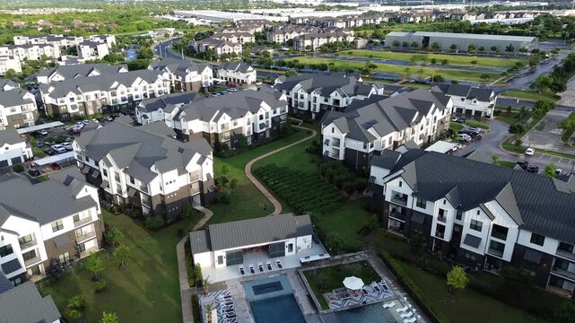 Swimming pool and resort style amenities in brand new apartment complex with metal roofing, farmhouses style rental community in Pflugerville, fast-growing city suburbs of North Austin, flyover