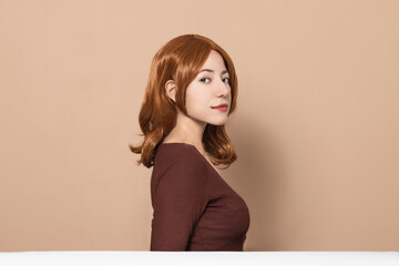 Beautiful woman with soft and healthy skin, silky hair, elegant look on minimalistic background....