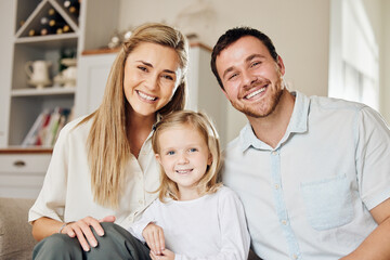Obraz premium Happy family, portrait and parents with girl on sofa in home for bonding, laughing and relax with love in living room. Smile, daughter and parenthood on couch in lounge on weekend, excited and caring